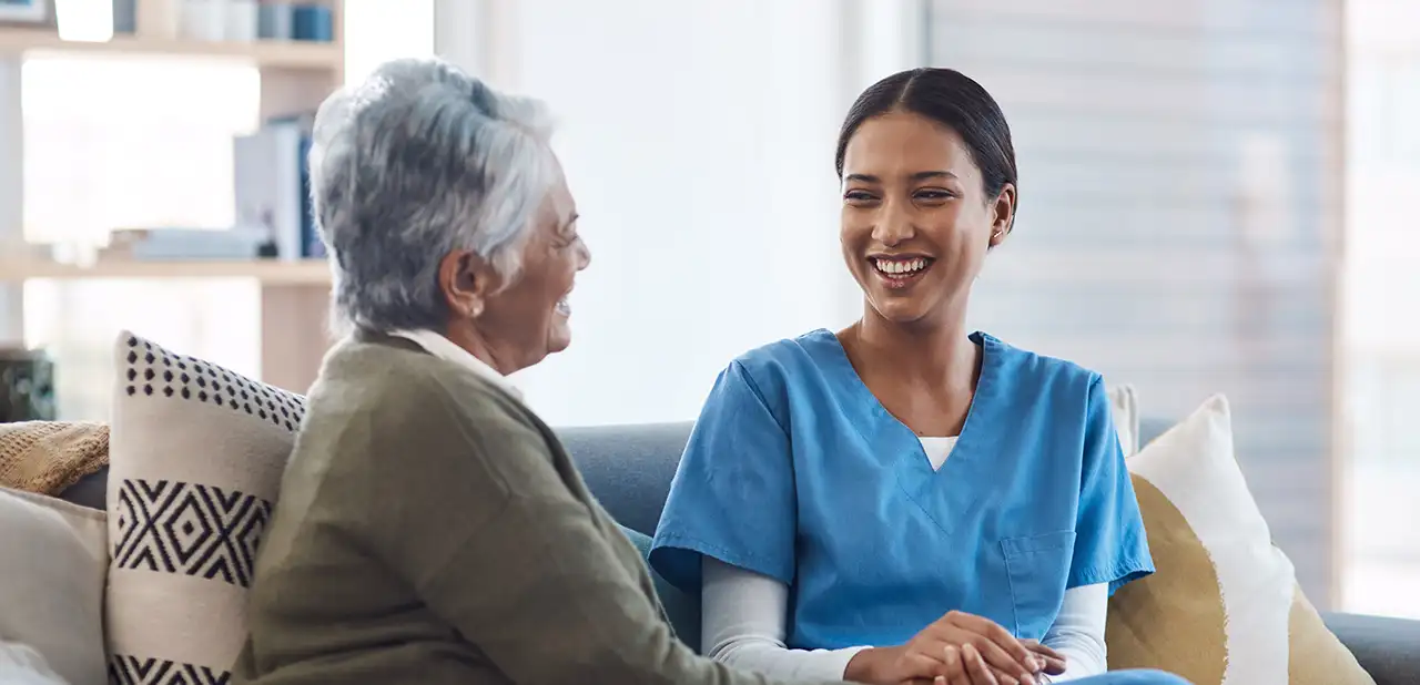 healthcare support nurse talking old woman nursing home visit checkup medical empathy female medicine professional having conversation with senior resident Guarding Life Home Care
