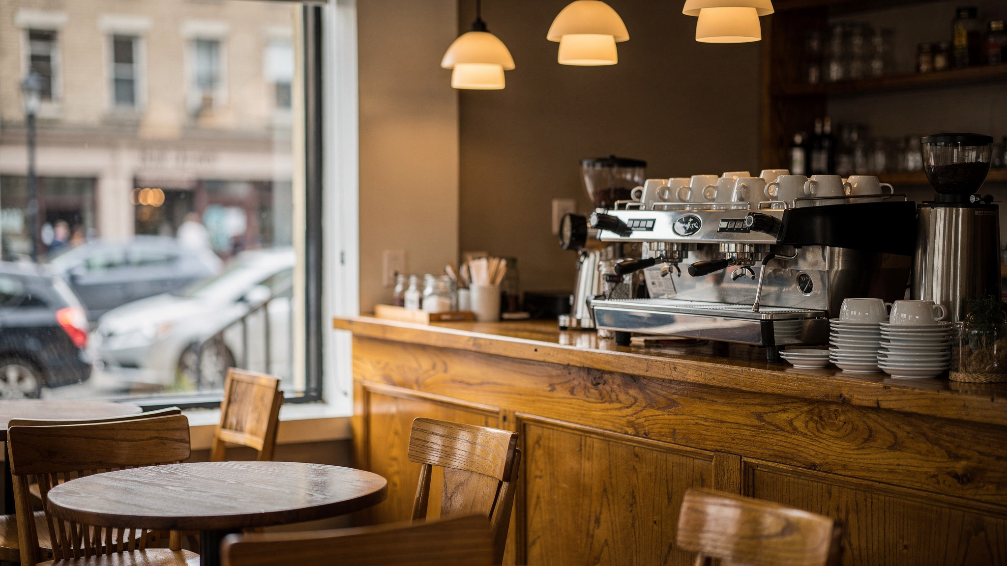 Cozy independent coffee shop interior with espresso machine and street view