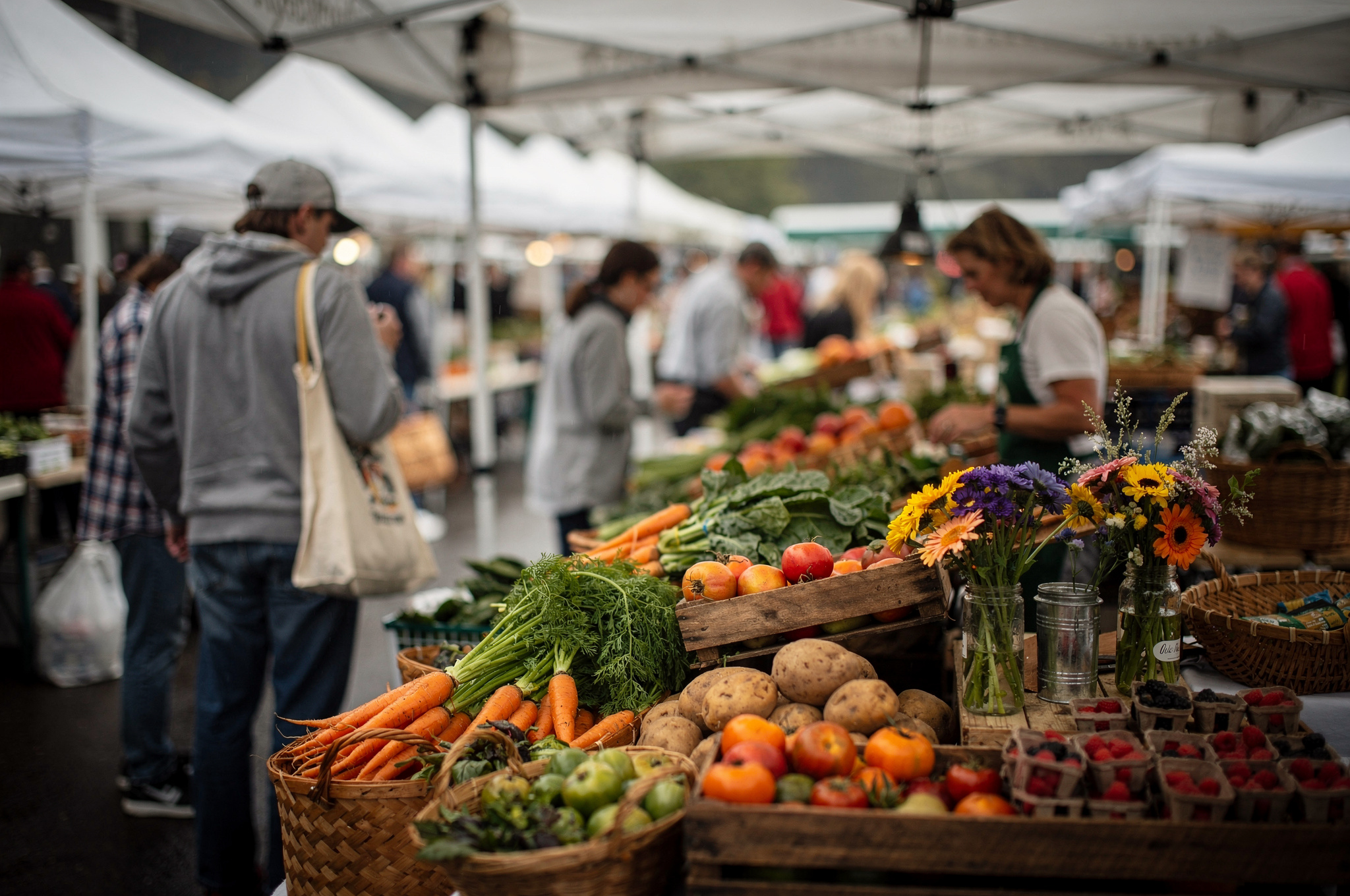 shoppers browsing fresh produce at a Delta farmers market stall