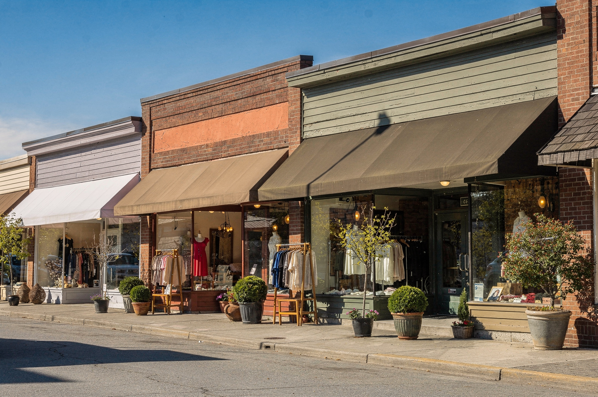 row of independent boutique storefronts on a South Delta shopping street